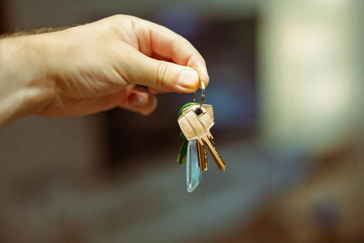 Hand holding out a set of keys